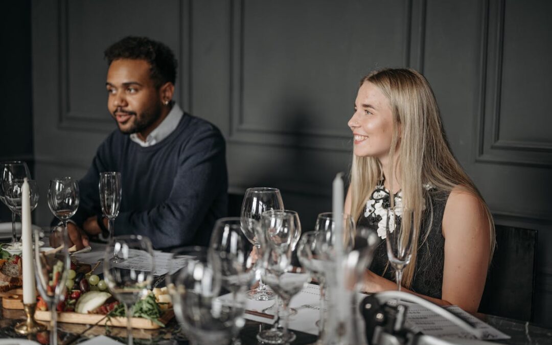 people sitting at a table that has catering food on it